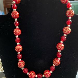 Fashion red and orange painted beaded necklace 20” long.